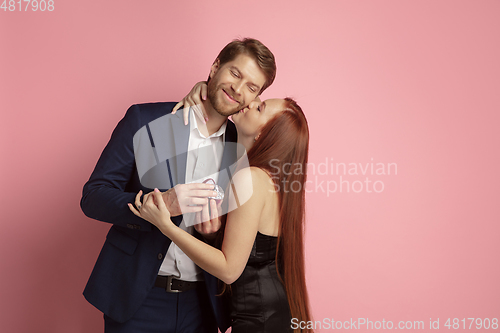 Image of Valentine\'s day celebration, happy caucasian couple isolated on coral background