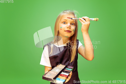 Image of Little girl dreaming about future profession of makeup artist