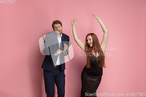 Image of Valentine\'s day celebration, happy caucasian couple isolated on coral background