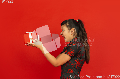 Image of Happy Chinese New Year. Asian young girls\'s portrait isolated on red background