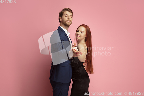 Image of Valentine\'s day celebration, happy caucasian couple isolated on coral background