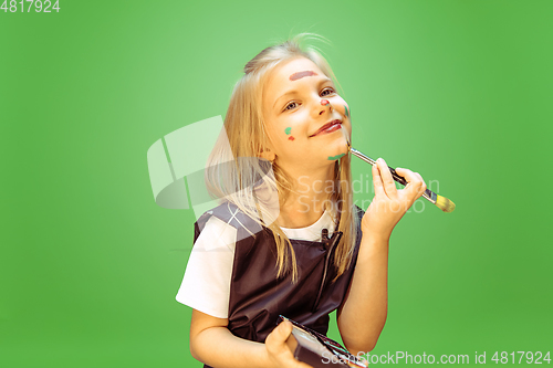 Image of Little girl dreaming about future profession of makeup artist