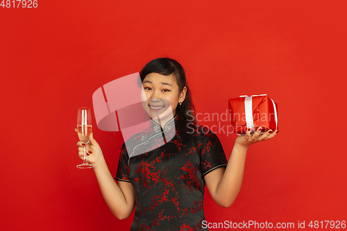 Image of Happy Chinese New Year. Asian young girls\'s portrait isolated on red background