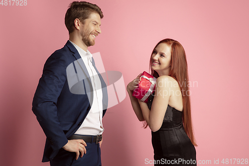 Image of Valentine\'s day celebration, happy caucasian couple isolated on coral background