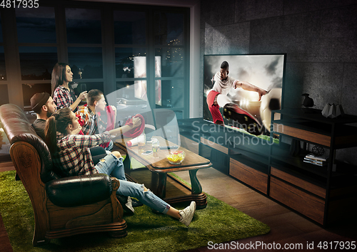 Image of Group of friends watching TV, sport concept, leisure activity