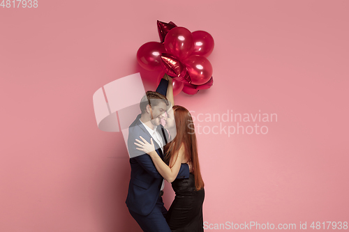 Image of Valentine\'s day celebration, happy caucasian couple isolated on coral background