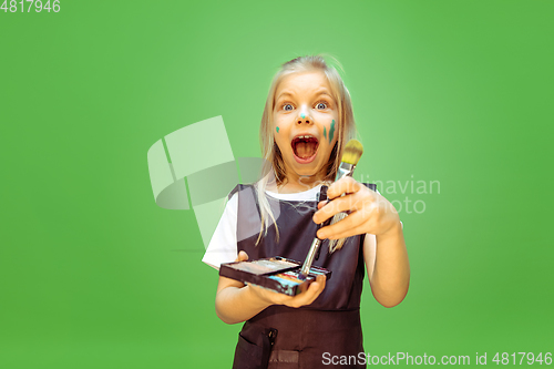 Image of Little girl dreaming about future profession of makeup artist