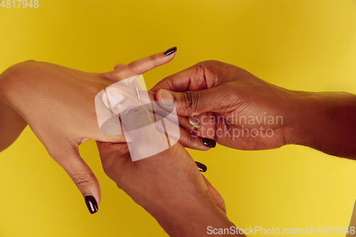Image of Valentine\'s day celebration, happy african-american couple isolated on yellow background