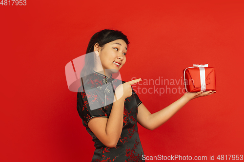 Image of Happy Chinese New Year. Asian young girls\'s portrait isolated on red background