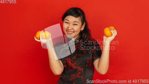 Image of Happy Chinese New Year. Asian young girls\'s portrait isolated on red background