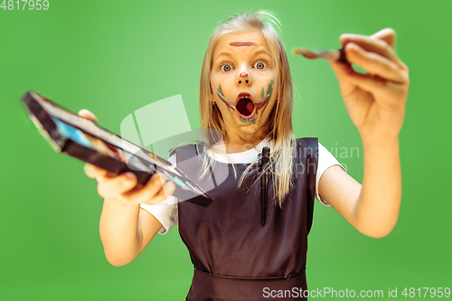 Image of Little girl dreaming about future profession of makeup artist