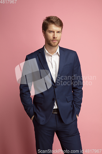 Image of Portrait of young caucasian man isolated on coral background