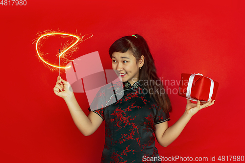 Image of Happy Chinese New Year. Asian young girls\'s portrait isolated on red background