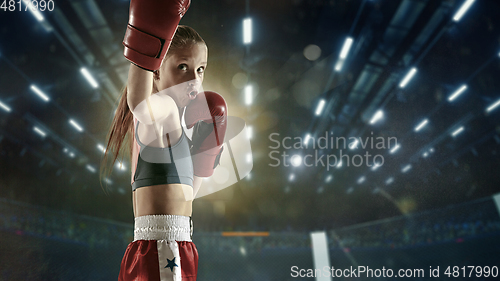 Image of Young female kickboxing fighter training in the gym