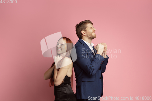 Image of Valentine\'s day celebration, happy caucasian couple isolated on coral background