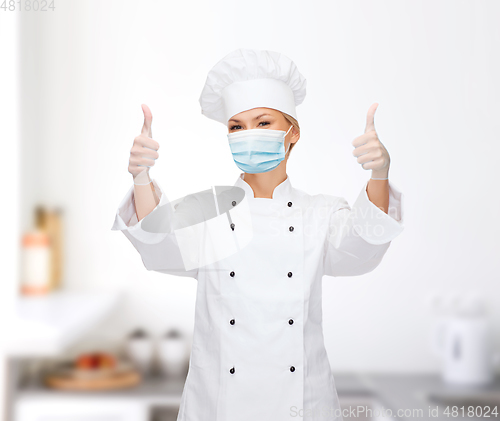 Image of female chef in face mask showing thumbs up
