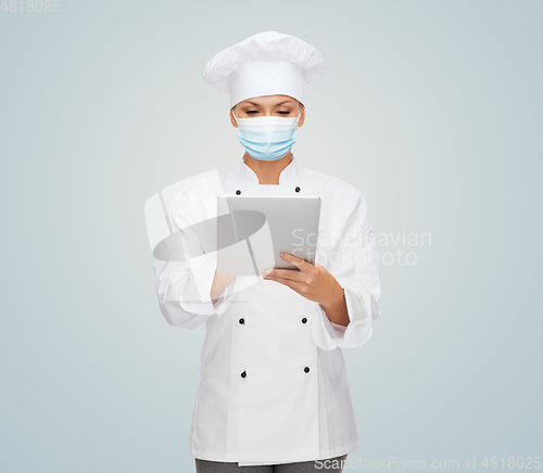 Image of female chef in face mask with tablet pc computer