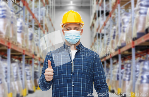 Image of male worker wearing face mask at warehouse