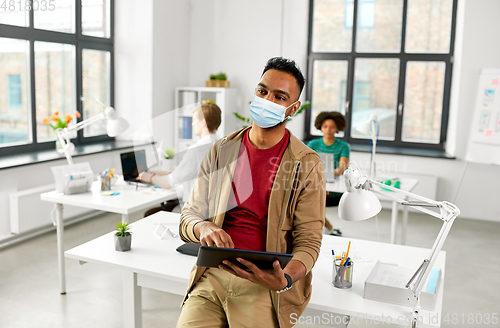 Image of indian man with tablet pc in face mask at office