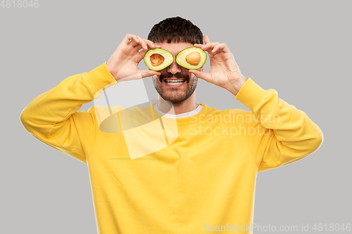 Image of happy young man with avocado instead of eyes