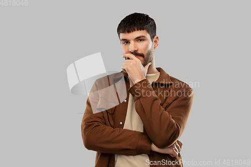 Image of portrait of thinking young man with mustaches