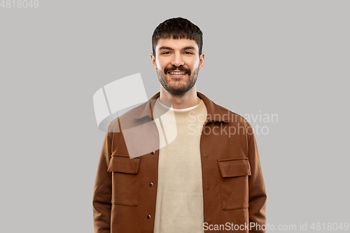 Image of portrait of happy smiling young man with mustaches