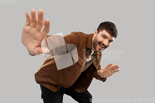 Image of happy smiling young man with mustaches