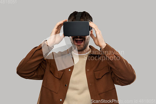 Image of happy smiling young man in vr glasses