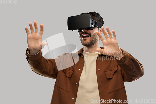 Image of happy smiling young man in vr glasses