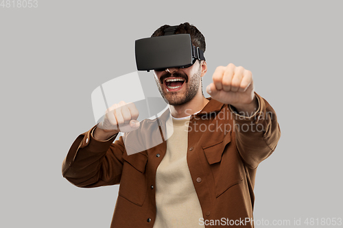 Image of happy smiling young man in vr glasses