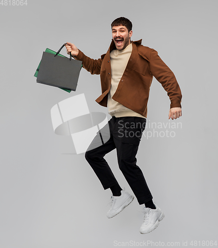 Image of happy smiling young man with shopping bags