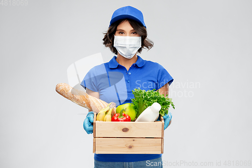 Image of delivery woman in face mask with food in box