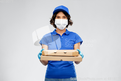 Image of delivery woman in face mask with pizza boxes