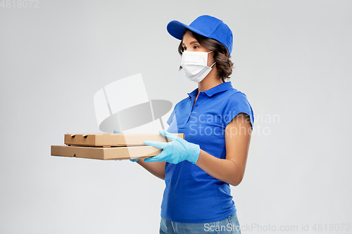 Image of delivery woman in face mask with pizza boxes