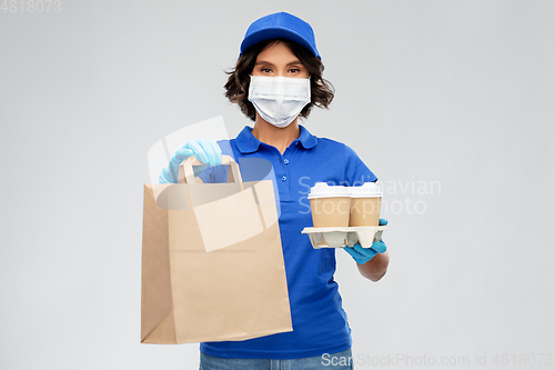 Image of delivery woman in face mask with food and drinks