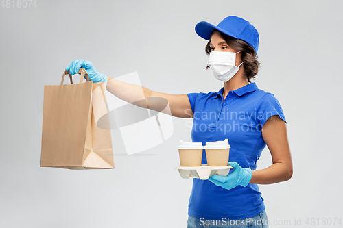 Image of delivery woman in face mask with food and drinks