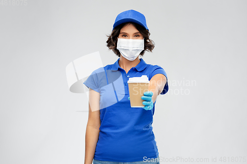 Image of saleswoman in face mask with takeaway coffee cup