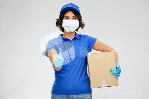 Image of delivery woman in face mask holding parcel box