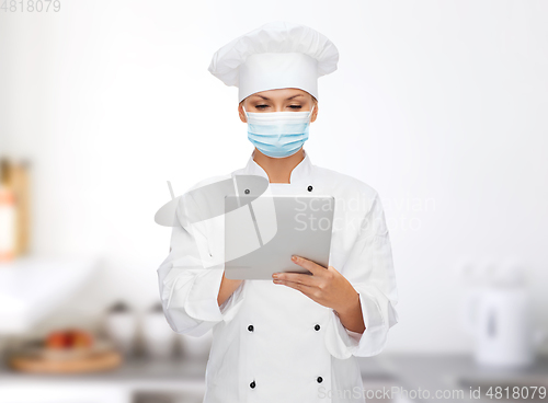 Image of female chef in face mask with tablet pc computer