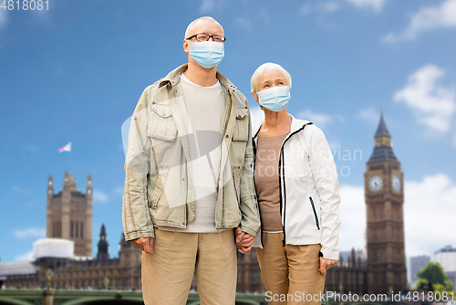 Image of senior couple in medical masks in london