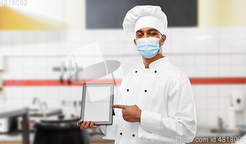 Image of male chef in face mask with tablet pc at kitchen