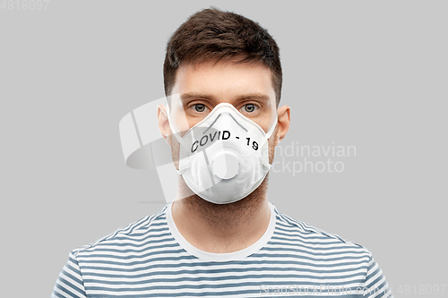 Image of young man in face protective mask or respirator