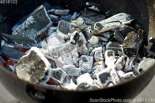 Image of charcoal smoldering in brazier outdoors