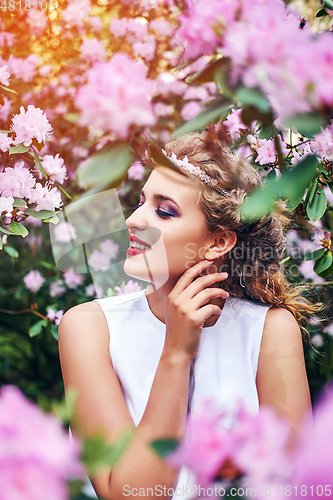 Image of girl in dress in rhododendron garden