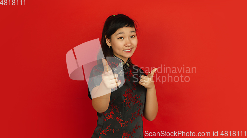 Image of Happy Chinese new year. Asian young girls\'s portrait isolated on red background