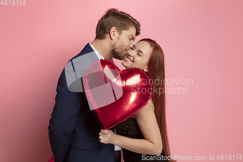 Image of Valentine\'s day celebration, happy caucasian couple isolated on coral background