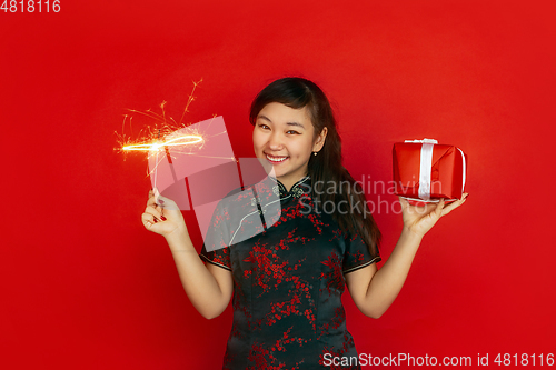 Image of Happy Chinese New Year. Asian young girls\'s portrait isolated on red background