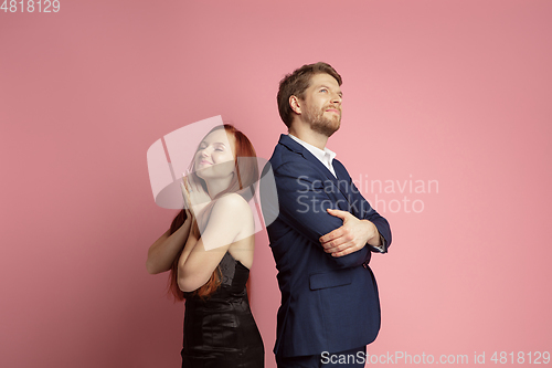 Image of Valentine\'s day celebration, happy caucasian couple isolated on coral background