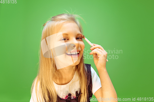 Image of Little girl dreaming about future profession of makeup artist