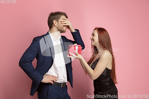 Image of Valentine\'s day celebration, happy caucasian couple isolated on coral background